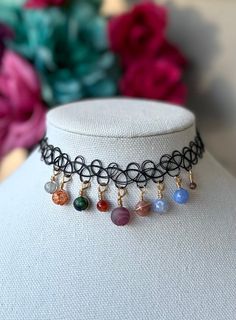 ITEM DESCRIPTION: Wire-wrapped solar system planet choker necklace made with crystal beads as the planets in order with Czech glass beads along the Saturn's rings. Some of the crystals are treated with dye and all are genuine crystals. The crystal sizes range from 4mm to 12mm in size. The crystal beads for each planet in order from left to right are as follows: Mercury: grey moonstone Venus: orange dyed quartz Earth: chrysocolla  Mars: carnelian agate Jupiter: purple agate  Saturn: peach moonsto Adjustable Metal Crystal Necklaces With Round Beads, The Planets In Order, Planets In Order, Saturn Ring, Solar System Necklace, Boho Witch, Grey Moonstone, Carnelian Agate, Dragon Vein Agate