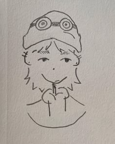 a drawing of a person wearing a hat and holding a pencil in their hand with eyes drawn on it