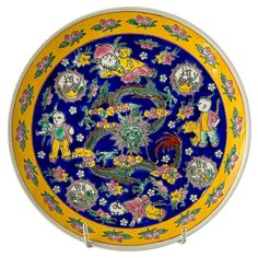 a blue and yellow plate with dragon designs on it