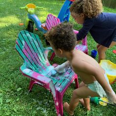 two children playing with toys in the grass