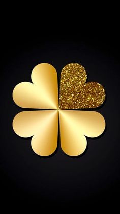 a gold shamrock with two hearts on it