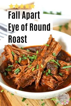 a white bowl filled with meat and sauce on top of a wooden table next to a fork