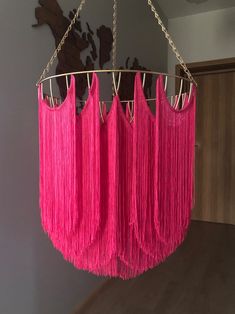 a pink chandelier hanging from a ceiling