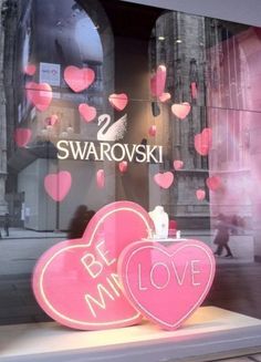 two pink hearts in front of a store window