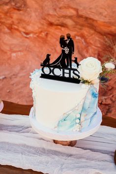 a wedding cake with a bride and groom on top