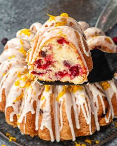 a close up of a bundt cake with icing and cranberries on it