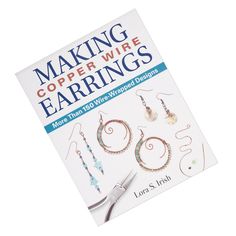 the book making copper wire earring's is shown with scissors and thread on it