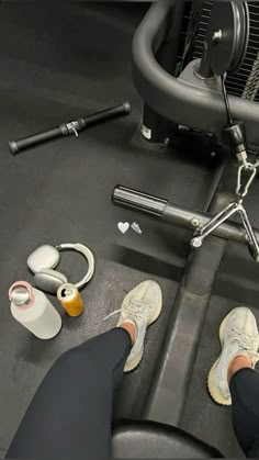 a person sitting on a bench with their feet propped up next to an exercise machine