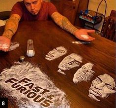 a man sitting at a table with his hands on the table and some flour in front of him