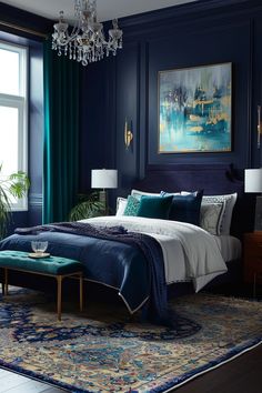 a bedroom with dark blue walls, white bedding and a chandelier hanging from the ceiling