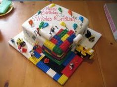 a birthday cake made to look like a lego house on top of a wooden table