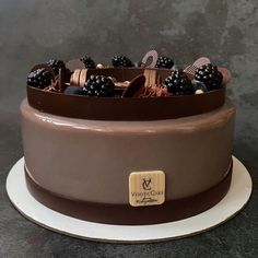 a chocolate cake with blackberries on top