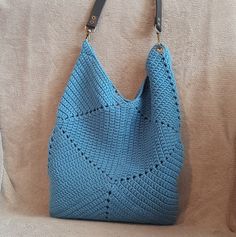 This is a high quality dark blue crocheted bag. The bag is completely made by hand. This fashionable bag will become an indispensable part of your wardrobe, suitable for any look and occasion. This wonderful handmade crocheted bag is the perfect accessory and a great gift for any holiday for your mother, sister, friend. Crochet gives the bag a soft, lightweight texture. Pleasant to the touch, a knitted bag is an excellent choice for any weather and any time of year. It has enough space to store your belongings and is not too small and not too big. To make knitted bags, we use both new and recycled materials of good quality, which allows us to respect the environment. Materials: cotton Cotton lining Lined pockets without fastening Height - 42 cm / 16,5 inch Width - 28 cm / 11 inch Detachabl Everyday Square Blue Hobo Bag, Everyday Blue Square Hobo Bag, Blue Knitted Shoulder Bag For Daily Use, Blue Bucket Bag With Braided Handles, Blue Shoulder Bucket Bag With Braided Handles, Bohemian Blue Rectangular Bucket Bag, Handmade Crochet Hobo Bag For Everyday Use, Handmade Hobo Crochet Bag For Everyday Use, Blue Bohemian Crochet Bag With Woven Details