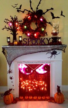 a fireplace decorated with halloween decorations and lights