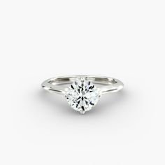 a white gold engagement ring with a single diamond