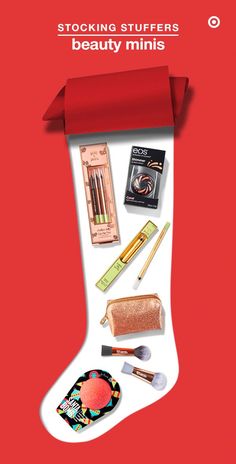 a christmas stocking with makeup, lipstick and other items in it on a red background