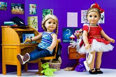 two dolls are sitting in front of a desk with a stuffed animal on the floor