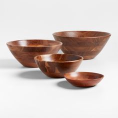 three wooden bowls sitting next to each other