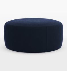 a round blue ottoman sitting on top of a white floor