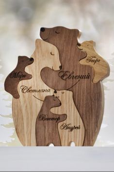 three wooden bears with names on them