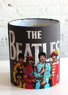 a lamp shade with the beatles band on it's front and back sides,