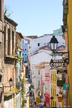 a narrow street with buildings and signs on it