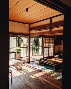 an empty room with wooden floors and sliding glass doors that open up to the outside