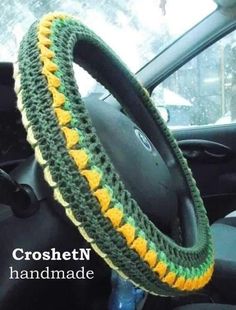 the steering wheel cover is crocheted with yellow and green yarn