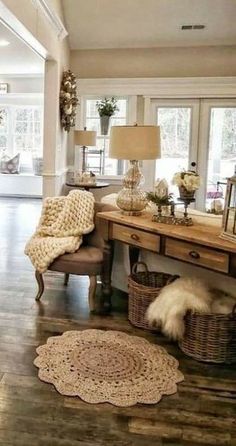 a living room filled with lots of furniture next to a wooden floor covered in rugs