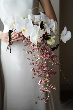 a woman holding a bouquet of flowers in her hands