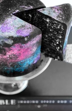 there is a cake with purple and blue icing on it