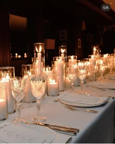 the table is set with candles and place settings