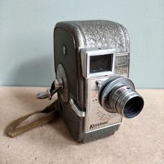 an old fashioned camera sitting on the ground