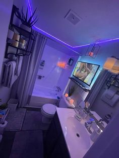 a bathroom with a television on the wall