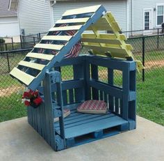 a wooden toy house made out of pallets