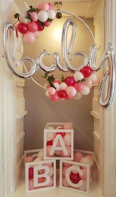 balloons and letters are hanging from the ceiling