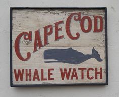 a sign on the side of a building that says cape god whale watch with an image of a fish