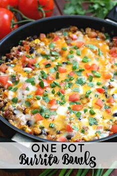 a skillet filled with mexican food and garnished with cilantro, green onions, black olives, and tomatoes