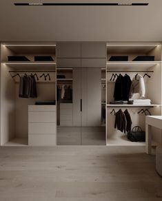 an empty walk in closet with clothes hanging on the shelves