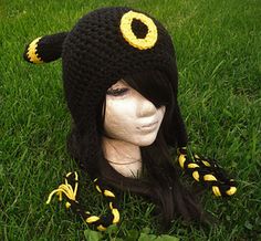 a crocheted hat with horns and ears on top of a mannequin head