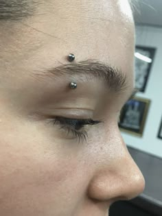 a woman with piercings on her forehead