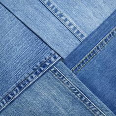 several different types of blue jeans stacked on top of each other, all showing stitchs