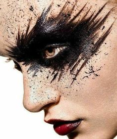 a woman's face with black and white makeup