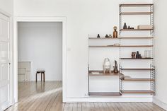 an empty room with white walls and wooden flooring is shown in the foreground