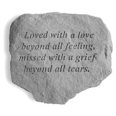 a stone with an inscription on it that says loved with a love beyond all feeling, missed