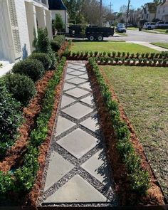 a stone walkway in front of a house