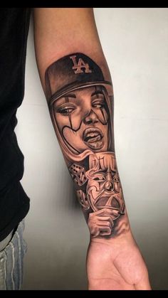 a man with a baseball cap on his arm is wearing a black and grey tattoo