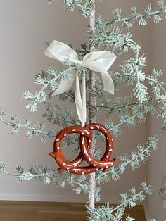 an ornament hanging from a tree with two pretzels in the middle