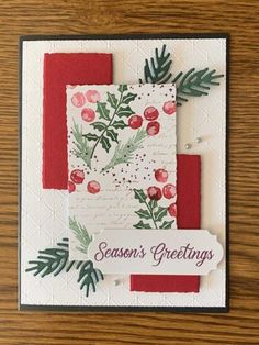 a handmade christmas card with holly and berries