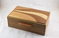 a wooden box sitting on top of a white sheet